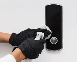 hands-with-gloves-disinfecting-door-bell (1)